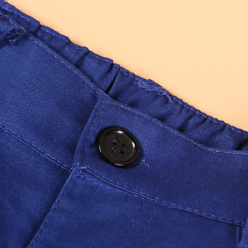 Blue three-piece boys suit with vest, tie, and trousers on a hanger