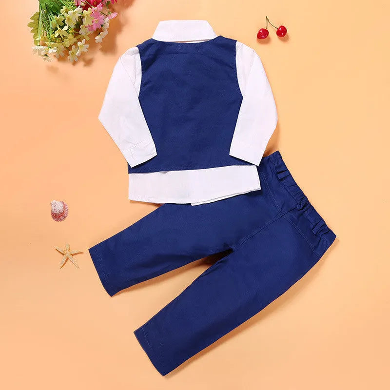 Blue three-piece boys suit with vest, tie, and trousers on a hanger