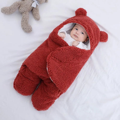 Baby quilted sleeping bag wrapper in cotton blend fabric, shown in a light blue colour.