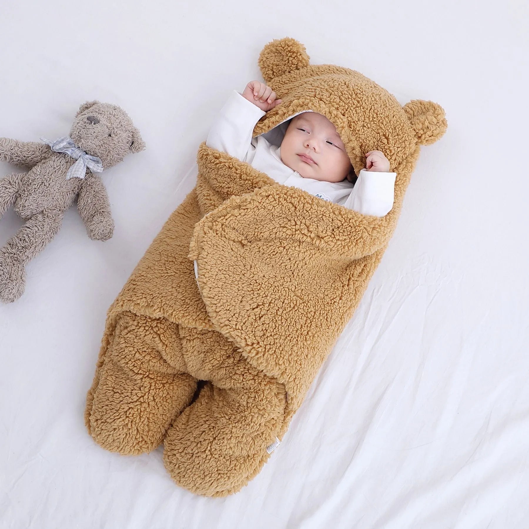 Baby quilted sleeping bag wrapper in cotton blend fabric, shown in a light blue colour.