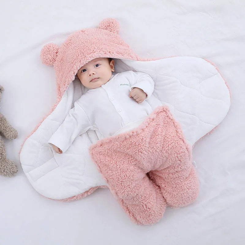 Baby quilted sleeping bag wrapper in cotton blend fabric, shown in a light blue colour.