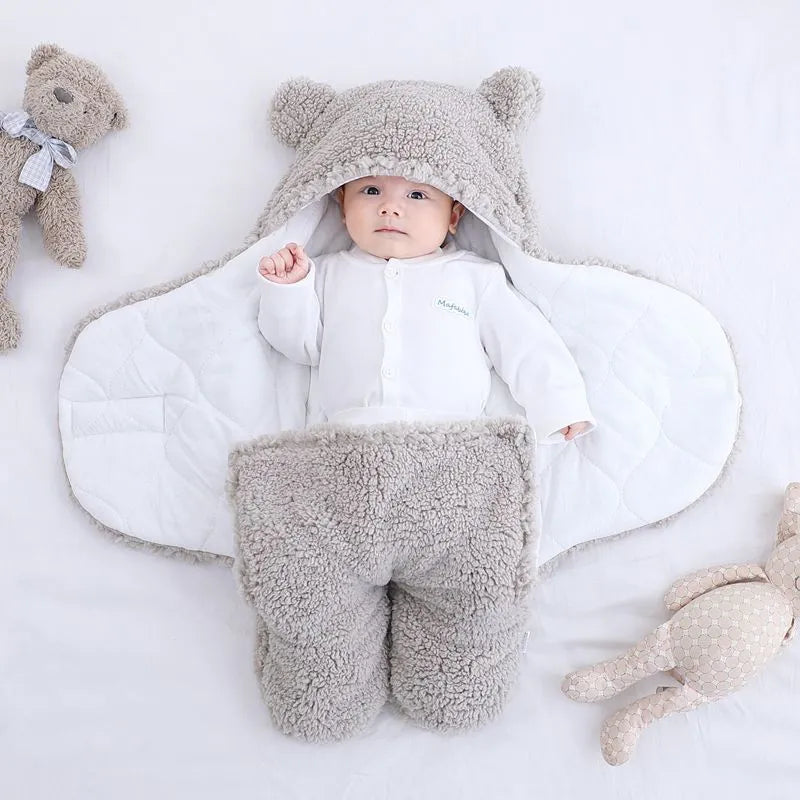 Baby quilted sleeping bag wrapper in cotton blend fabric, shown in a light blue colour.