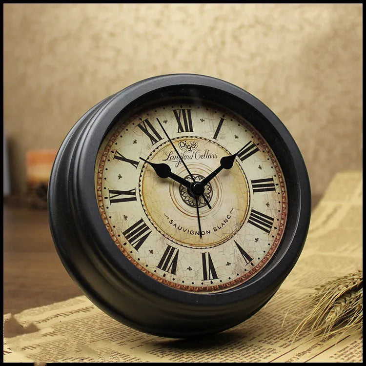Round European-style retro desk alarm clock with a silent sweep second hand on a wooden desk.