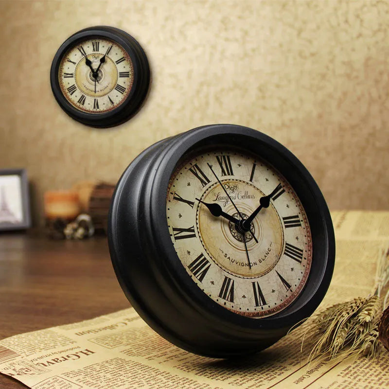 Round European-style retro desk alarm clock with a silent sweep second hand on a wooden desk.
