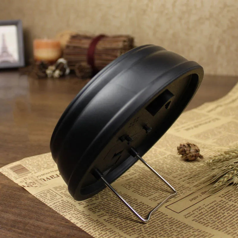 Round European-style retro desk alarm clock with a silent sweep second hand on a wooden desk.