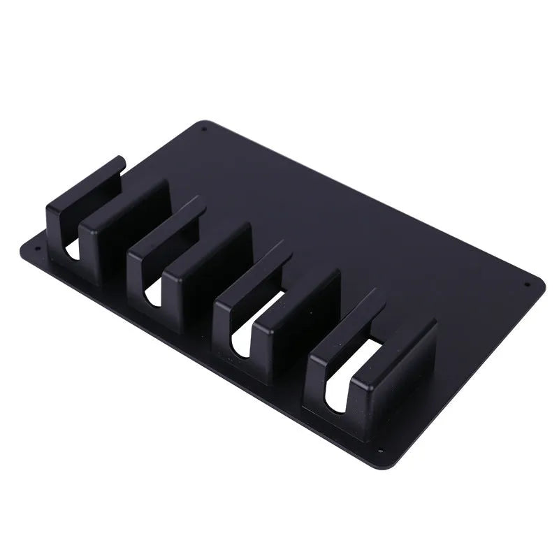 Black plastic wall-mounted rack holding four hair clippers with screws for assembly