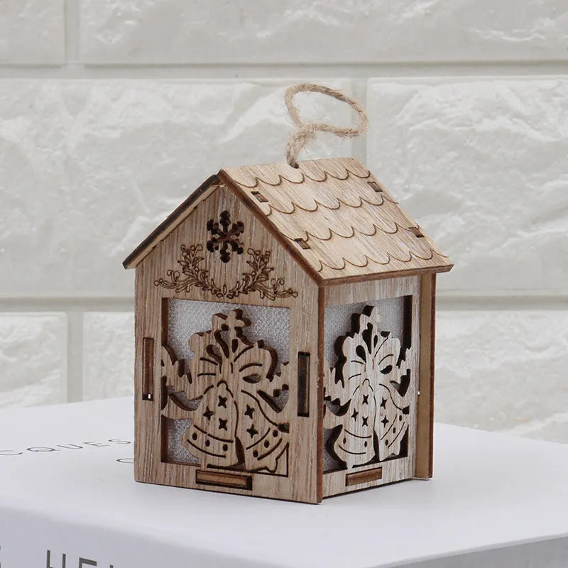 Set of three handmade wooden Christmas cottage ornaments: log bell, Santa house, and snowman house.