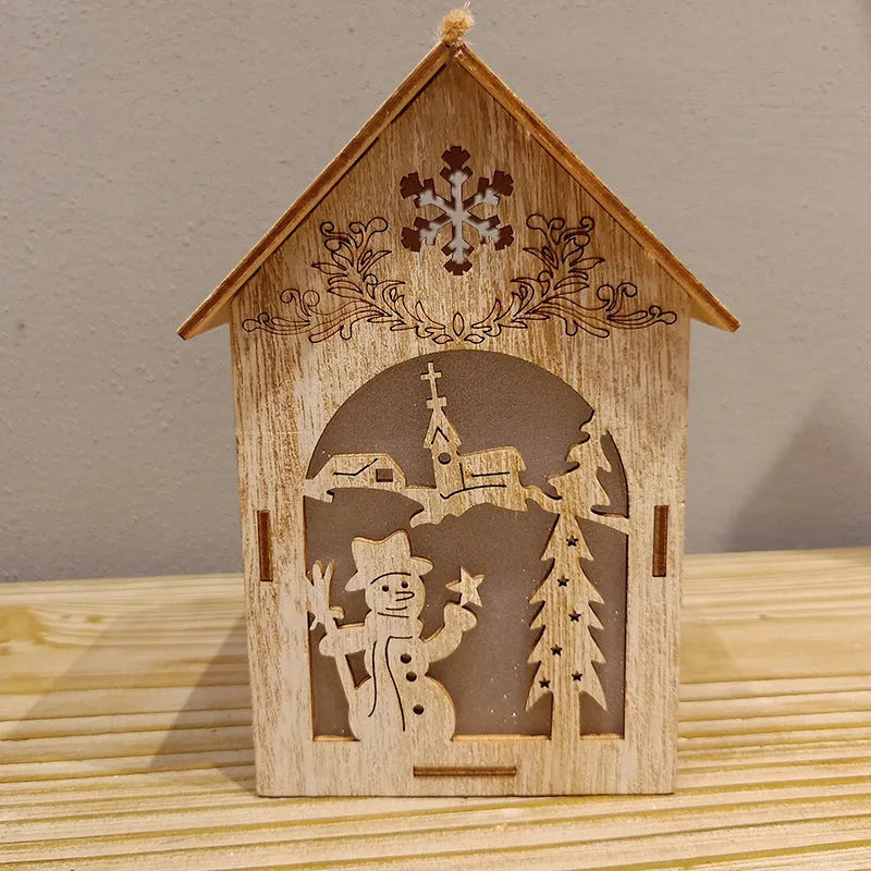 Set of three handmade wooden Christmas cottage ornaments: log bell, Santa house, and snowman house.