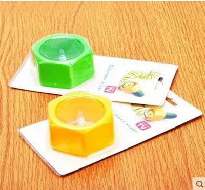 Yellow and green ABS plastic spiral vegetable cutter for slicing cucumbers.