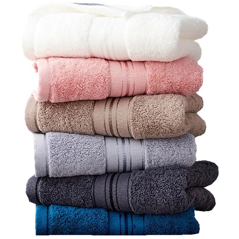 Three-piece cotton towel set showing bath towel, hand towel, and square scarf in solid blue colour