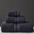 Three-piece cotton towel set showing bath towel, hand towel, and square scarf in solid blue colour