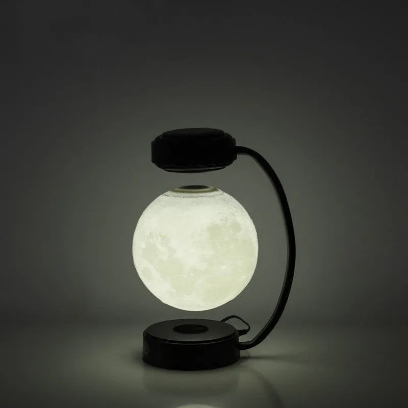 Magnetic levitation moon lamp floating above base with touch controls and 3-colour lighting