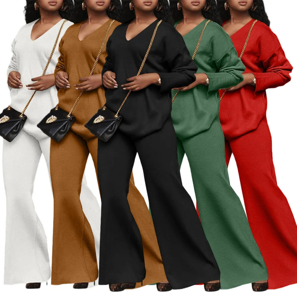 Women's brown thickened velvet two-piece suit with split sleeve top and trousers on a hanger.