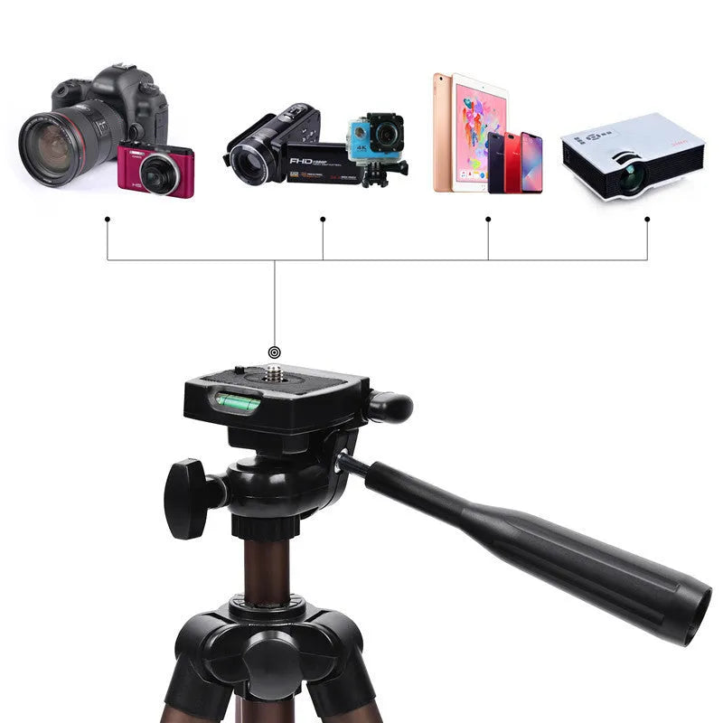 Aluminium camera tripod extended to 1.3m with hydraulic head, mobile phone holder, and Bluetooth remote on a table.