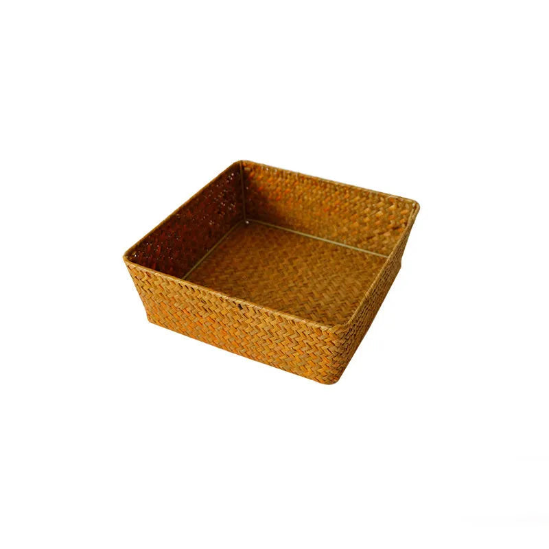Brown woven straw desk storage box with lid shown on wooden surface