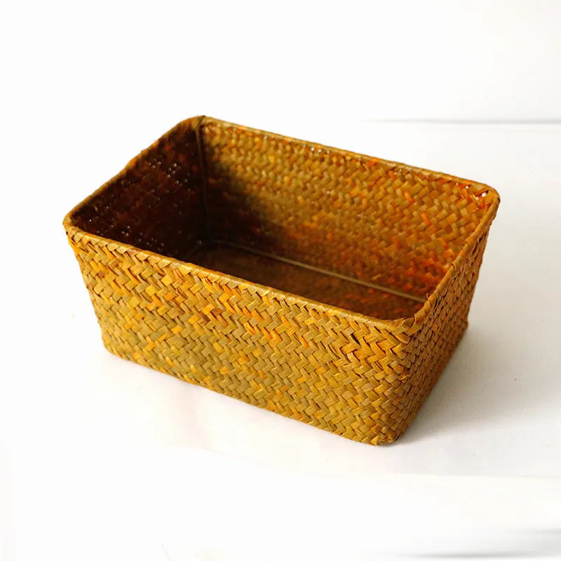 Brown woven straw desk storage box with lid shown on wooden surface