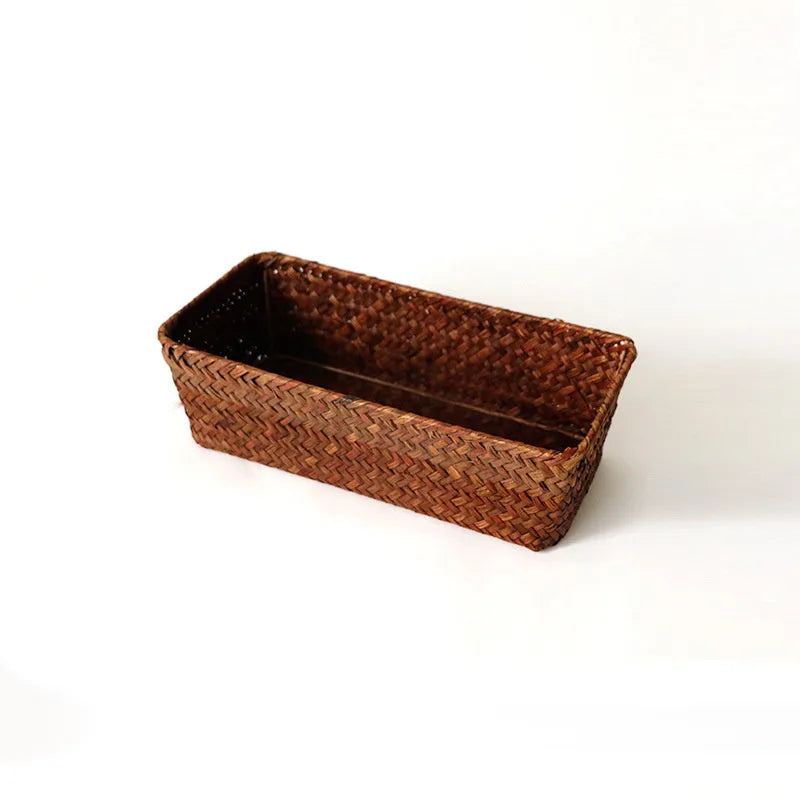 Brown woven straw desk storage box with lid shown on wooden surface