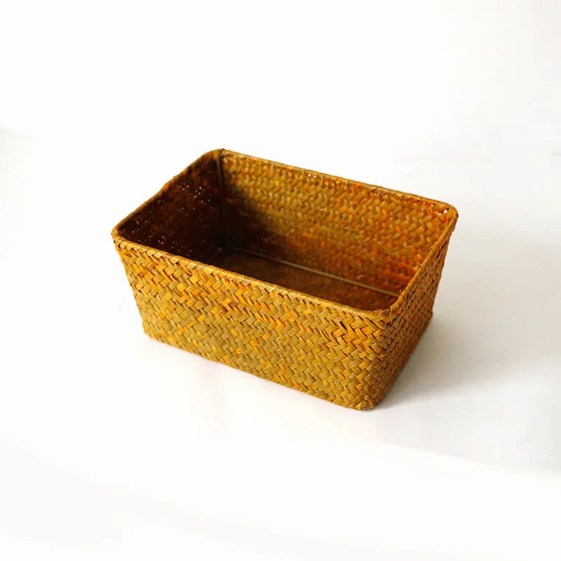 Brown woven straw desk storage box with lid shown on wooden surface
