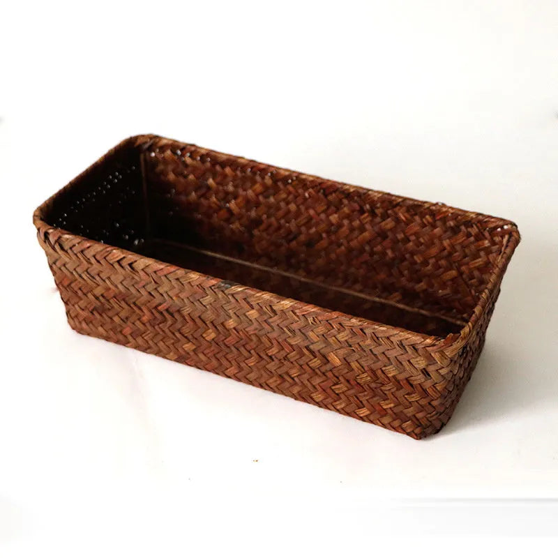 Brown woven straw desk storage box with lid shown on wooden surface