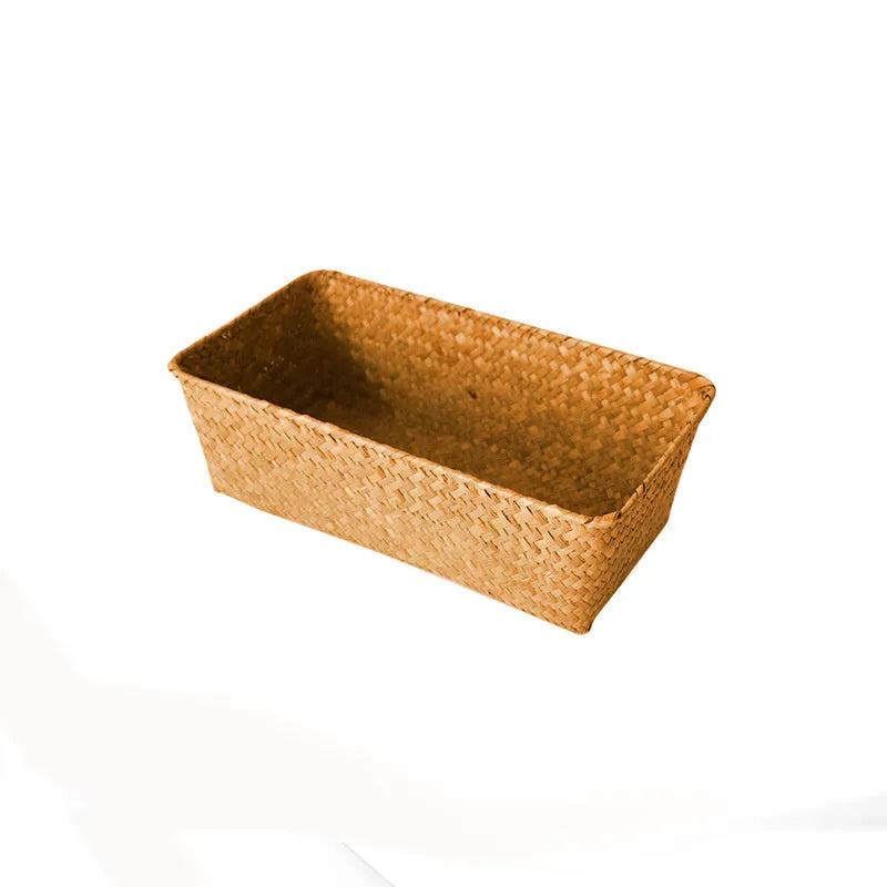 Brown woven straw desk storage box with lid shown on wooden surface