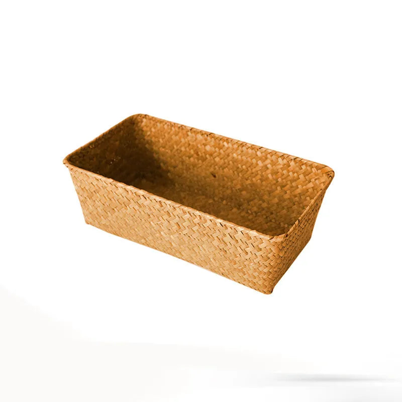 Brown woven straw desk storage box with lid shown on wooden surface