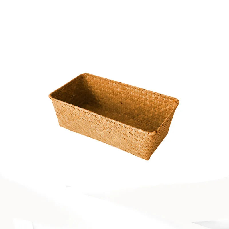 Brown woven straw desk storage box with lid shown on wooden surface