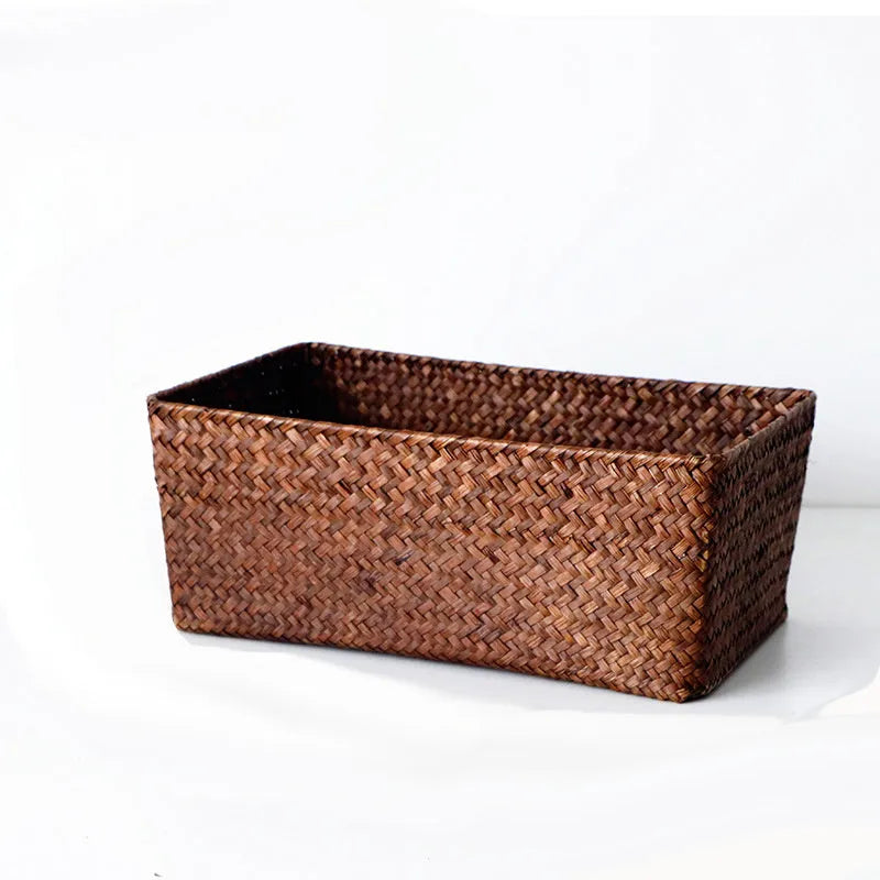 Brown woven straw desk storage box with lid shown on wooden surface