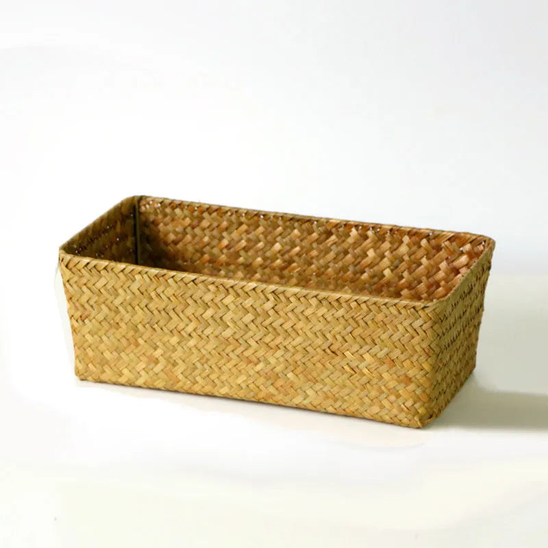 Brown woven straw desk storage box with lid shown on wooden surface