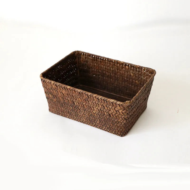 Brown woven straw desk storage box with lid shown on wooden surface