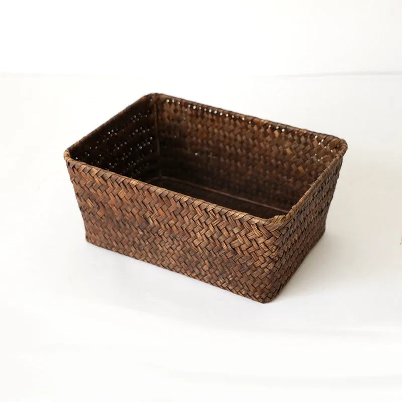 Brown woven straw desk storage box with lid shown on wooden surface