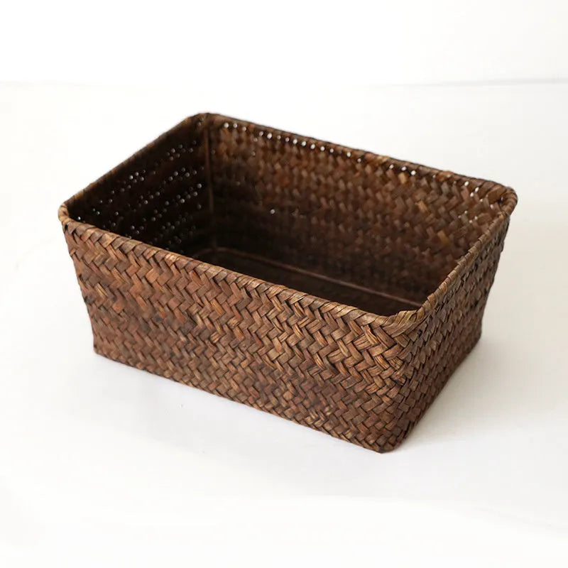 Brown woven straw desk storage box with lid shown on wooden surface