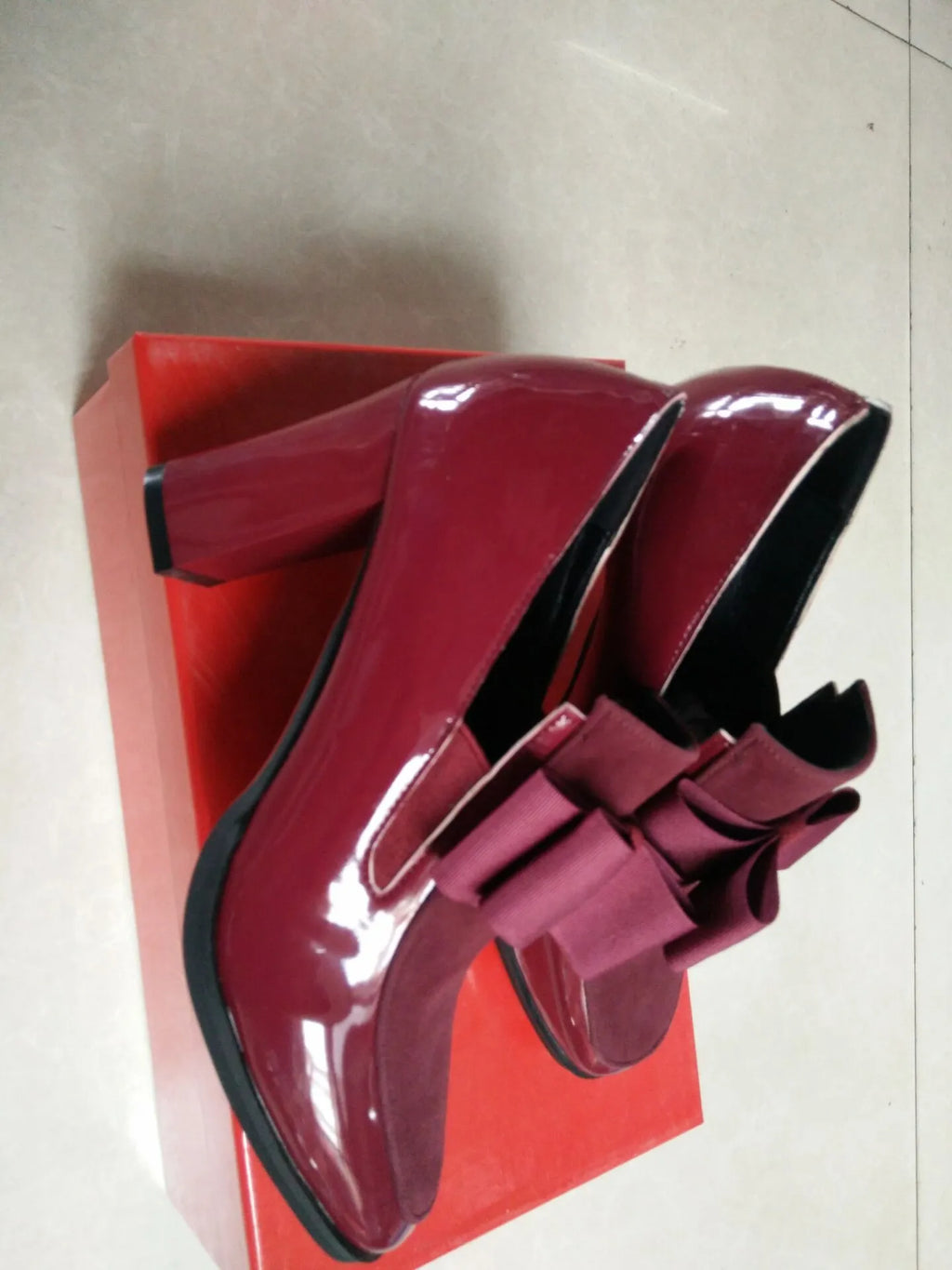 Women's black patent leather high heels with a thick block heel and square toe.