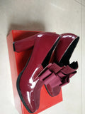Women's black patent leather high heels with a thick block heel and square toe.