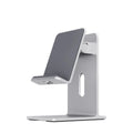 Dark Space Gray alloy mobile phone holder with a phone secured in its adjustable cradle on a wooden desk.