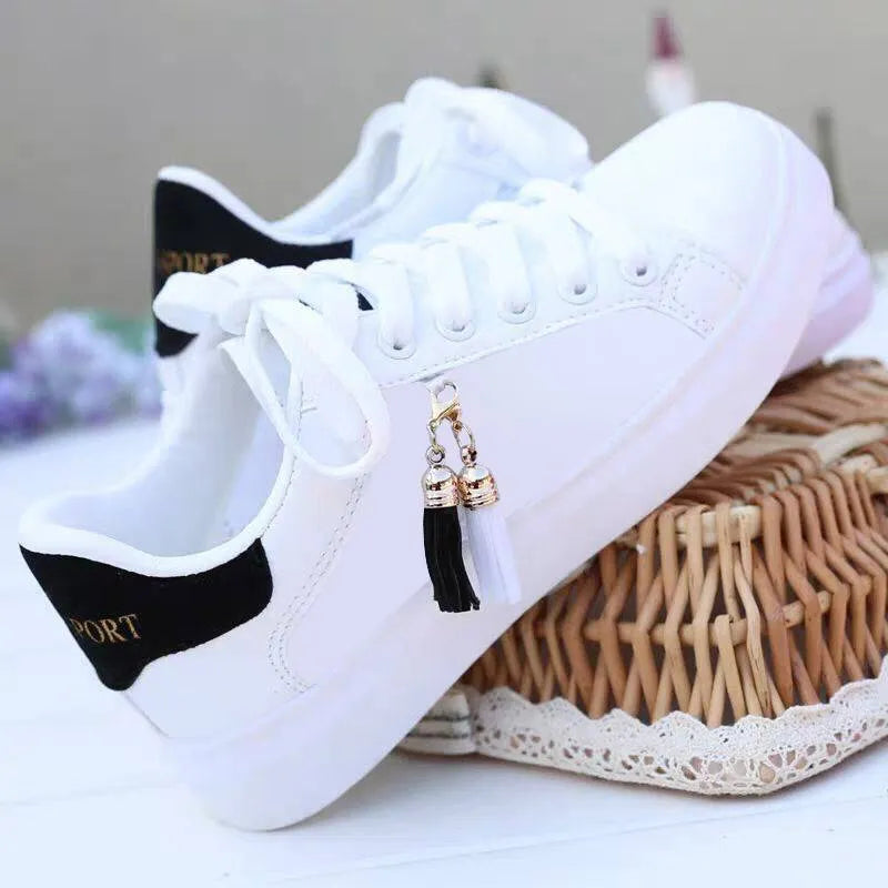 Women's white mesh casual shoes with pink accents and rubber sole on grey background