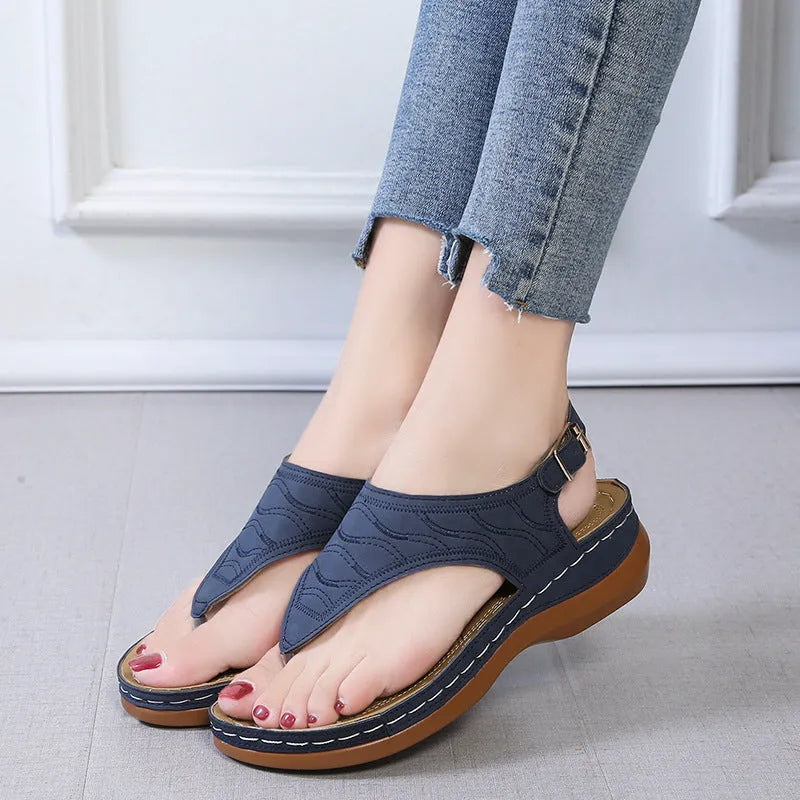 Women's black casual wedge heel flip flop sandals with an adjustable buckle strap.