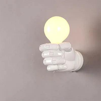 Creative resin fist sculpture wall lamp in black, mounted on a wall as a decorative light fixture.