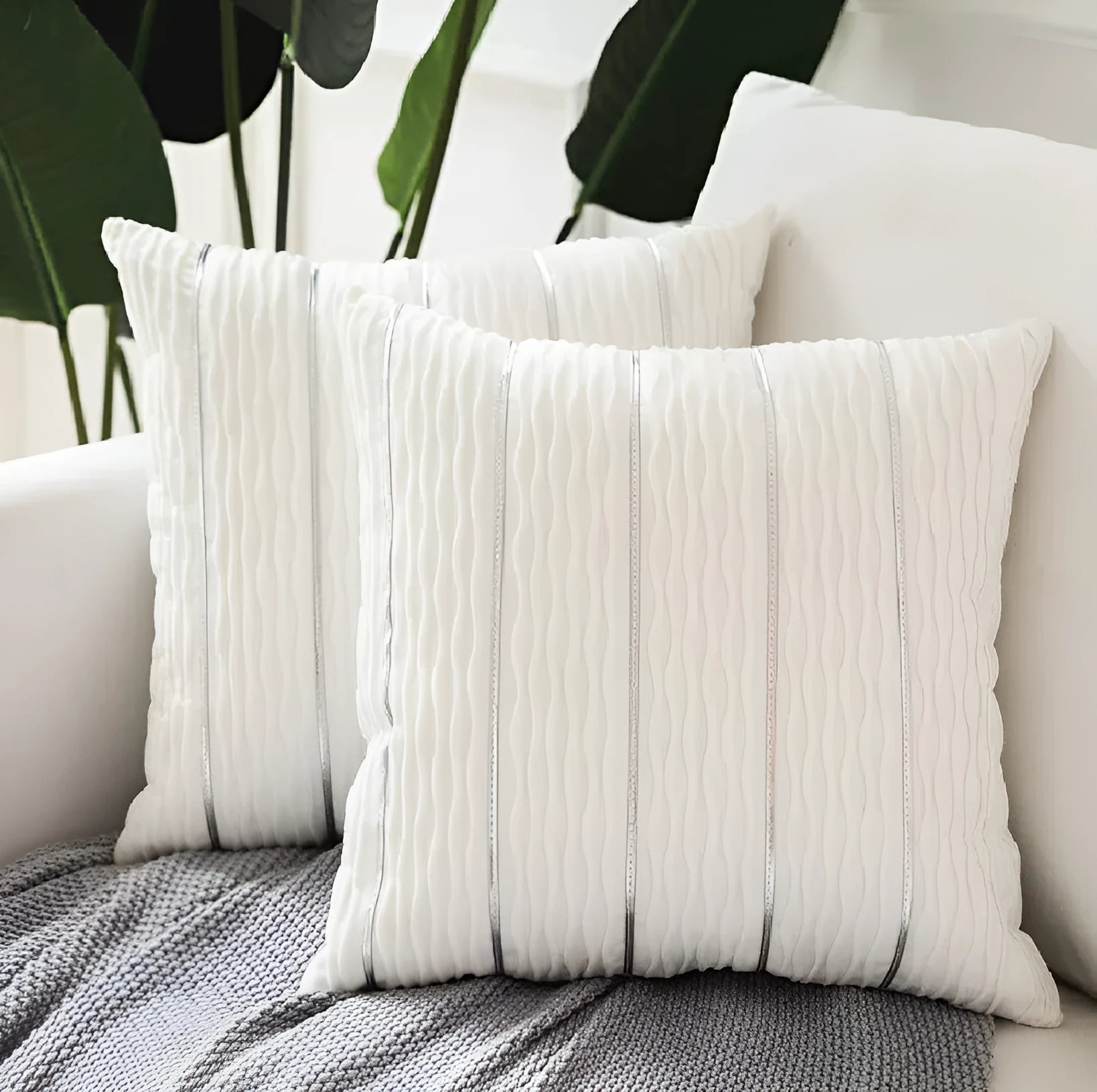 Square striped velvet pillow cover for sofa in multiple colour options on a grey background.