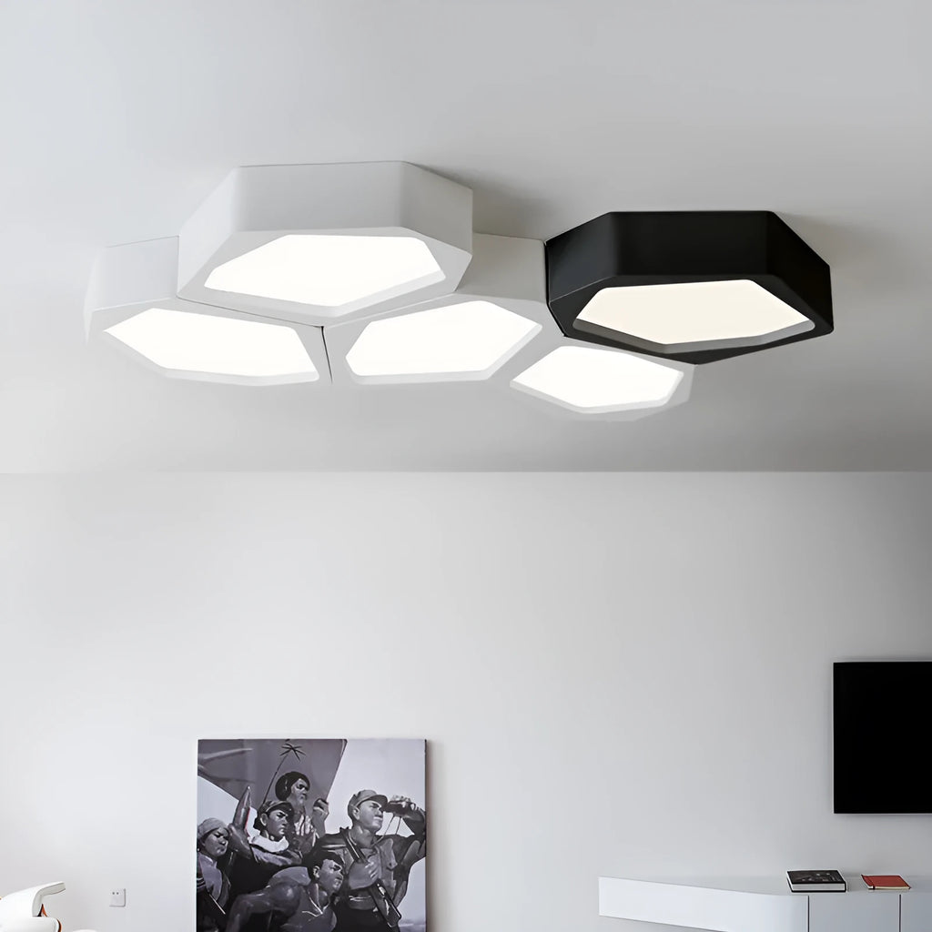 Geometric shaped iron LED light with black frame and remote control on a table.