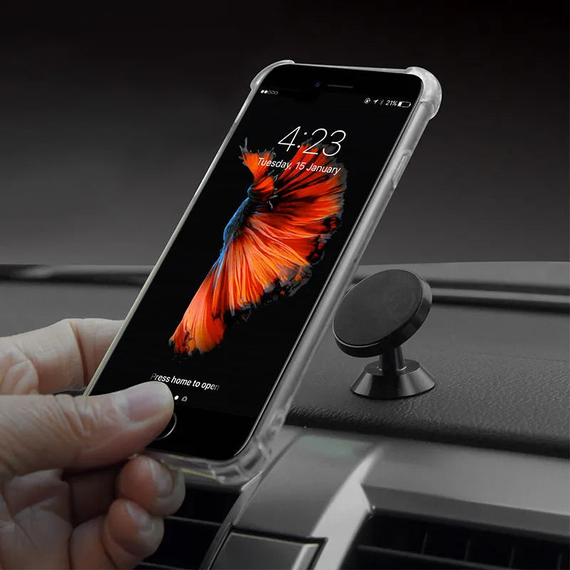 Universal magnetic car phone holder in black, silver, and gold colours on a car dashboard.