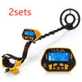 GC1028 black and yellow metal detector with LCD screen and adjustable pole on grass.