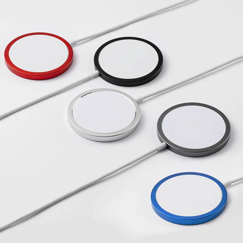 Silver metal Magsafe-compatible magnetic wireless charger for iPhone on a wooden desk