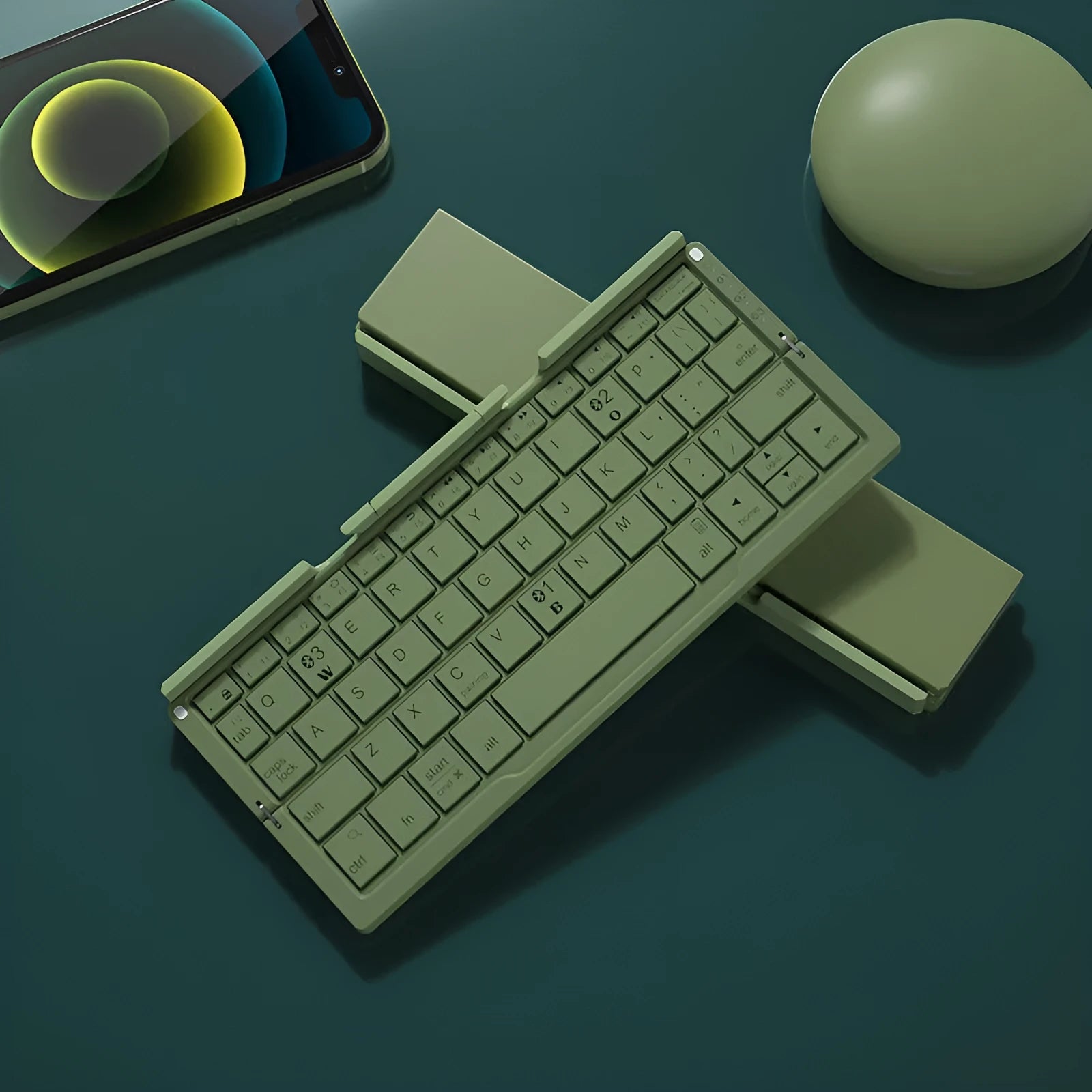 Silver white folding Bluetooth keyboard shown open with stand supporting a smartphone