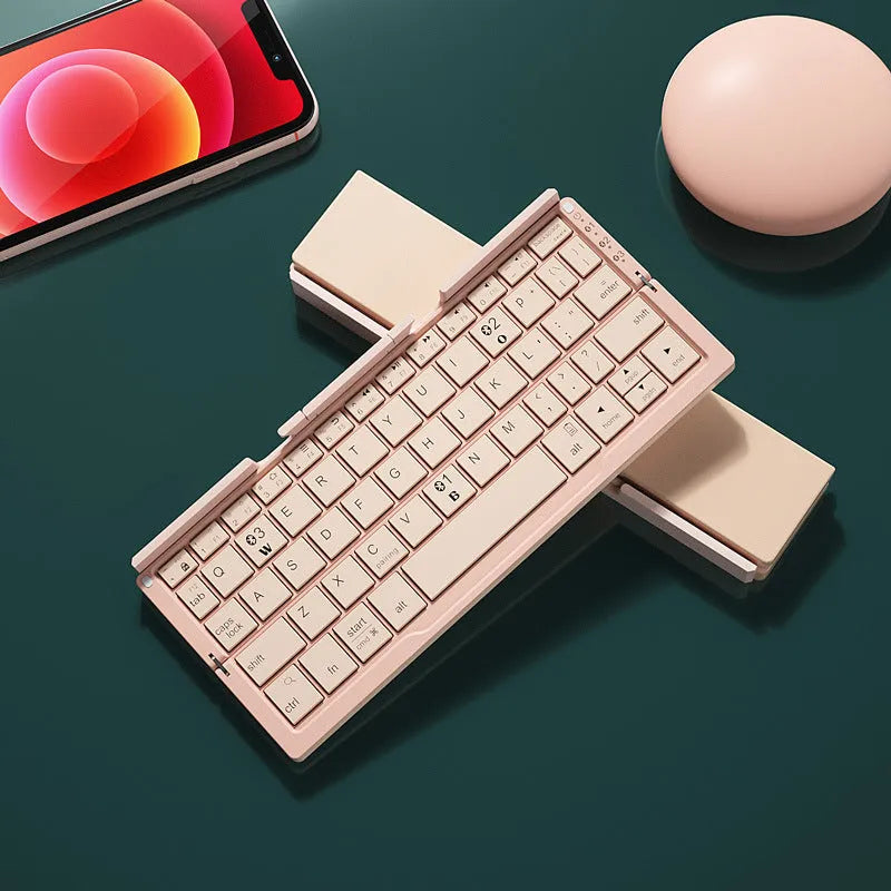 Silver white folding Bluetooth keyboard shown open with stand supporting a smartphone