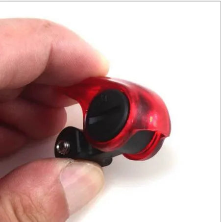 Mini bicycle brake warning light with red LED, black ABS housing, and stainless steel spring for V-brakes