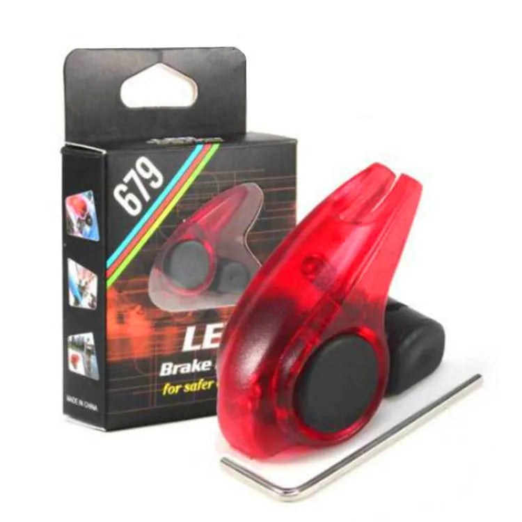 Mini bicycle brake warning light with red LED, black ABS housing, and stainless steel spring for V-brakes