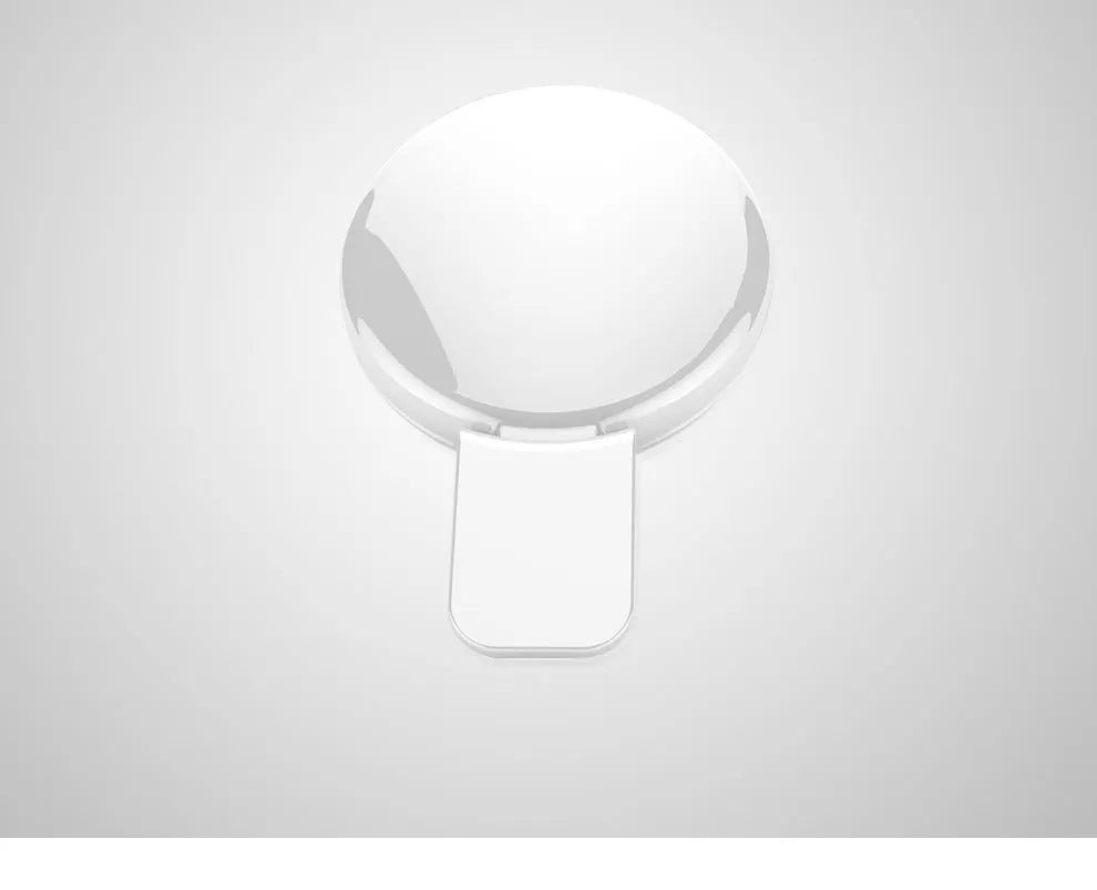 Round USB rechargeable LED fill light attached to a mobile phone for selfies.