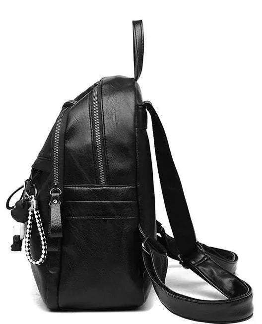 Black soft-surface pu leather backpack with double straps and luggage strap, showing main compartment.