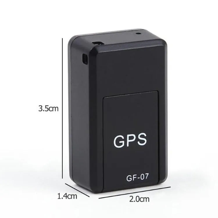 Small black magnetic GPS tracker device next to a USB charging cable on a table.