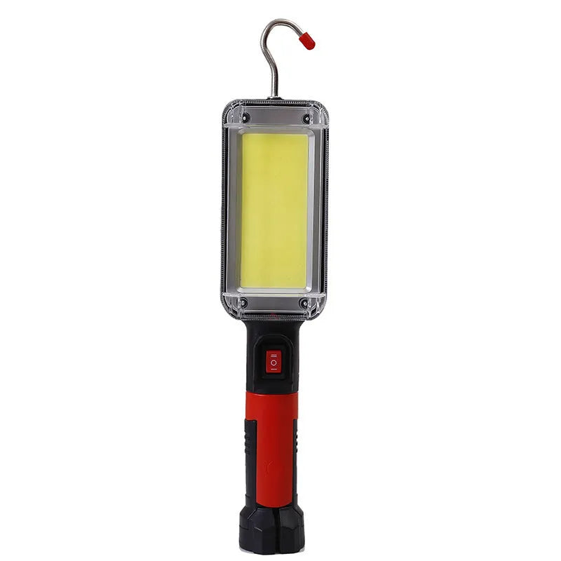 Red portable COB rechargeable work lamp with magnetic hook on a metal surface.